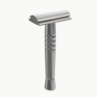Silver safety razor on a white background
